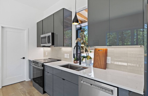Young Harris Apartment | Escape to a 2BR/1BA tiny home in the North Georgia mountains. Create meals in the chef’s kitchen, cozy up by the wood-burning stove, refresh in the spa-style shower, and enjoy crisp mountain air and brilliant fall colors from your private deck.