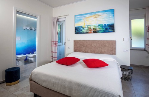 Cala Gonone Bed & Breakfast | Family room with mountain view terrace and window overlooking the harbor.