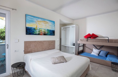 Cala Gonone Bed & Breakfast | Family room with mountain view terrace and window overlooking the harbor.