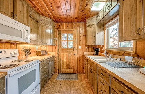 West Village House | Friendly cabin-style home with private gas grill, wood-burning stove, & deck