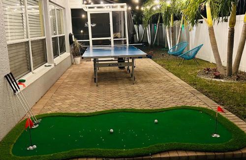 Fort Myers House | Game Room with Poolside Bar and a Heated Pool with Ping Pong and Putting Green
