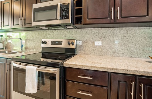 Villarreal Condo | Gated resort condo with on-site pool, outdoor areas, private patio, & W/D