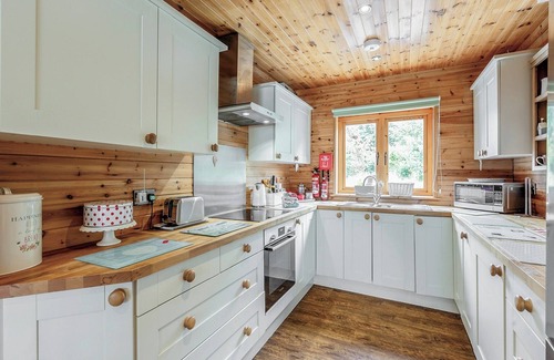 Menai Bridge Ski Chalet | Ground floor: Spacious open plan lounge, kitchen, dining area with log burner.