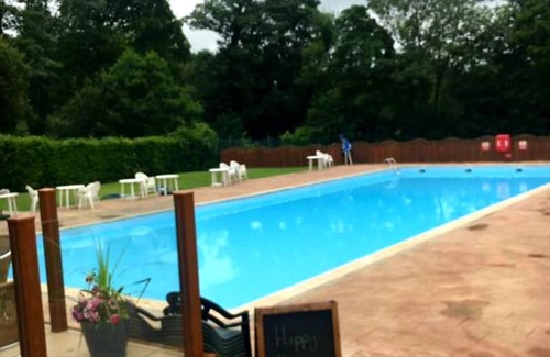 Bont Newydd Ski Chalet | Hillside Hideaway Chalet With Swimming Pool, Play Area, Fishing Lake