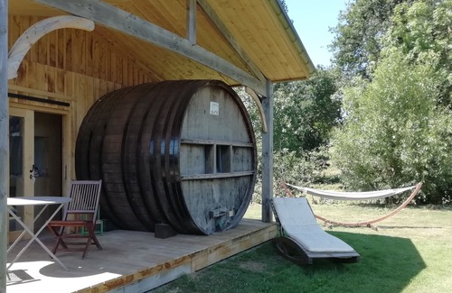 Baguer-Pican Cabin | INSOLITE A barrel in a green setting