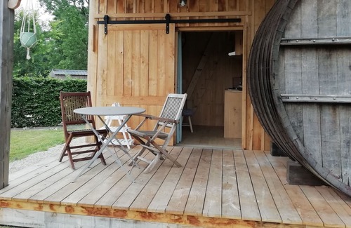 Baguer-Pican Cabin | INSOLITE A barrel in a green setting