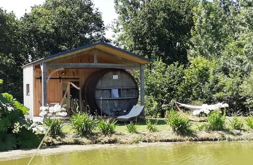 Baguer-Pican Cabin | INSOLITE A barrel in a green setting