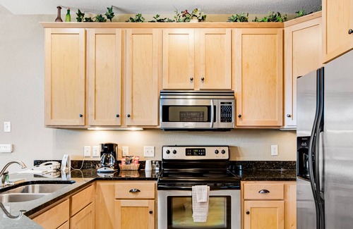 Three Lakes Condo | Lake-view condo with pool and hot tub access, jetted tub, firepit, and a balcony
