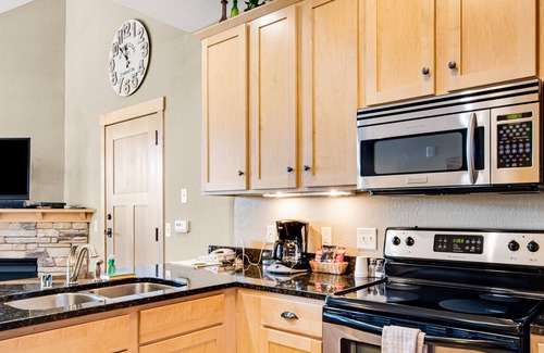Three Lakes Condo | Lake-view condo with pool and hot tub access, jetted tub, firepit, and a balcony
