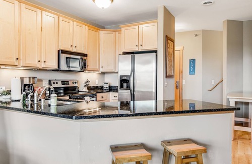 Three Lakes Condo | Lake-view condo with fireplace, loft, washer/dryer, pools, hot tubs, & firepit