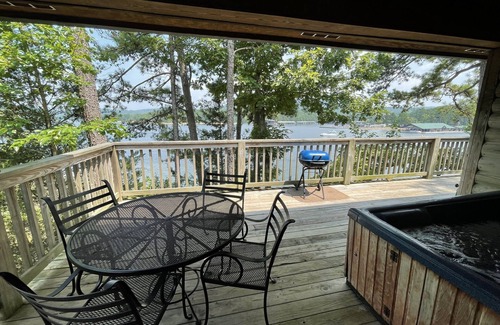 Mount Ida Cottage | Lake view two bedroom, two bath loft, log-sided cottage with private hot tub overlooking Lake Ouachita. by RedAwning