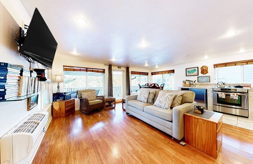 Mason County House | Lakefront studio-like home with beach access, lake views, wood stove, & firepit