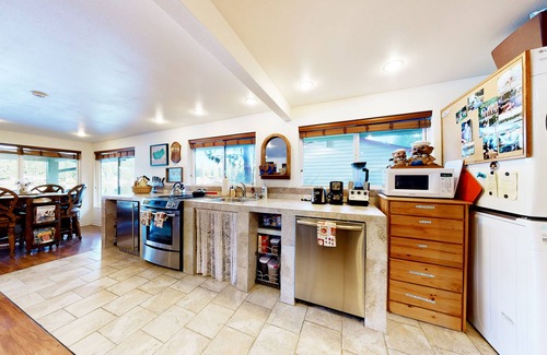 Mason County House | Lakefront studio-like home with beach access, lake views, wood stove, & firepit