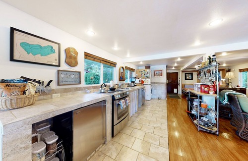 Mason County House | Lakefront studio-like home with beach access, lake views, wood stove, & firepit