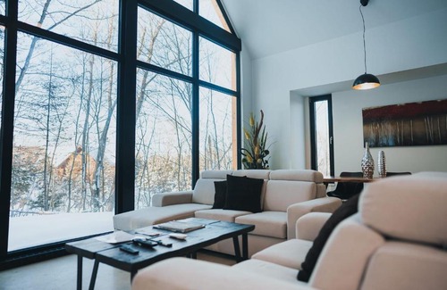 Lac Superieur Village House | Large windowed chalet surrounded by nature