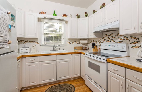 Demere Park House | Little Gingerbread Cabin Two Bedroom Two Bath Home with Rocking Chair Porch