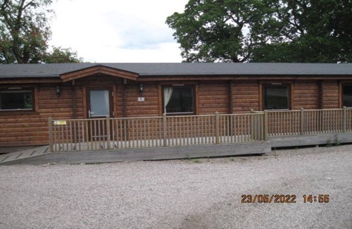 Kenwick Cabin | Log cabin with decked veranda, nestled in Kenwick Park, Louth