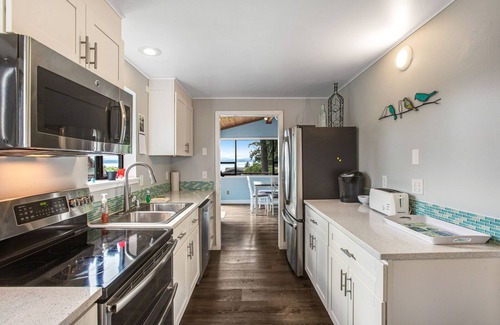 Freeland House | Log-style mountain and bay-view retreat with hot tub, game rooms, & balcony