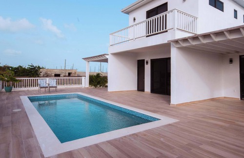 Leeward Settlement Apartment | Lush 2-Story Villa, Poolside Bliss Near Beach
