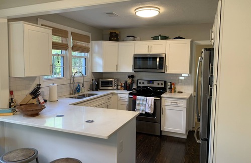 Pendleton King House | Masters rental with spacious back porch, fenced in yard, and park frontage.
