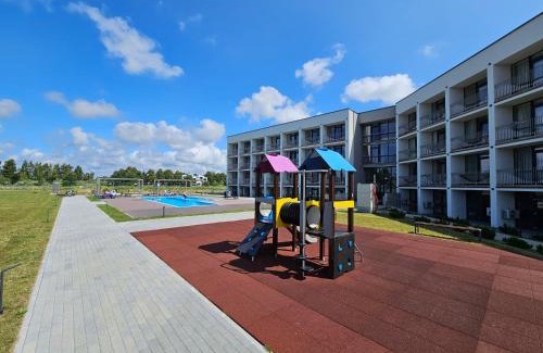 Sventoji Apartment | Mindaugo apartamentai su šildomu baseinu, sporto sale, vaikų kambariu, work zona