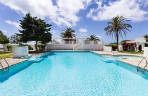 Binisafua Apartment | Modern Bungalow "Binisafua Playa - Bungalow 14" Near the Beach with Shared Outdoor Pool, A/C, Wi-Fi, Terrace & Garden; Parking Available
