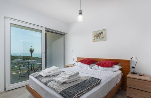 Peruski House | Modern vacation home with pool and sea view.
