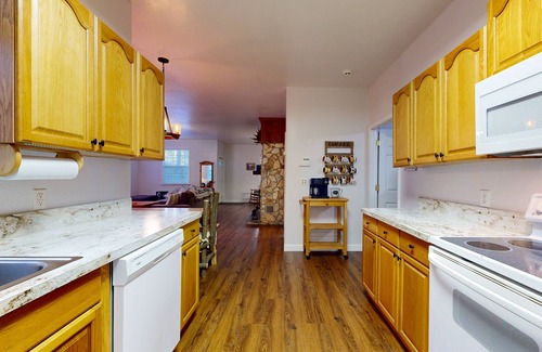 Sylva House | Mountain view home with a fireplace with beautiful view of the creek