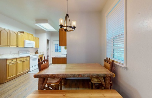 Sylva House | Mountain view home with a fireplace with beautiful view of the creek