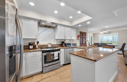 Balboa Peninsula Apartment | Oceanfront Boardwalk property, Newly remodeled Large patio, Steps to the sand.