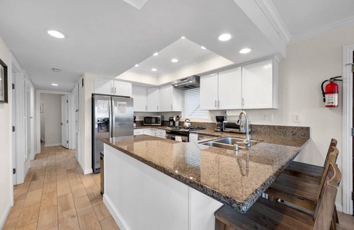 Balboa Peninsula Apartment | Oceanfront Boardwalk property, Newly remodeled Large patio, Steps to the sand.