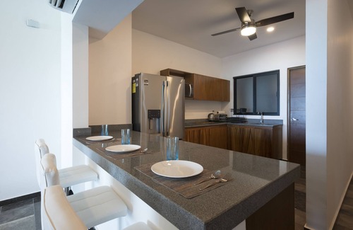 Ixil Apartment | Oceanfront retreat with private balcony, outdoor pool, and stunning views