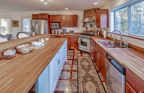 Belfast House | Ornate lake view home with wraparound deck, dock access & W/D