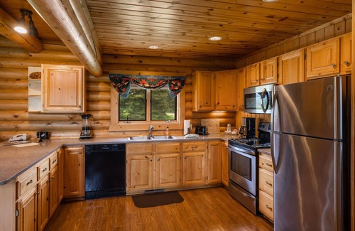 Ennis House | Our ultimate luxury Montana log cabin. Special highlights include a vaulted ceiling, an expansive rock fireplace and spectacular views of the Madison Range.