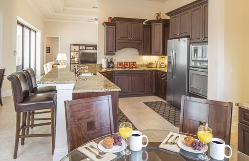 Central Naples House | overlooking a nature preserve and lake, this pool with spa home has it all