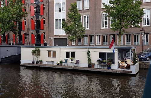 Grachtengordel-West Boat Rental | Pantheos Houseboat in Prinsengracht with a view of the Westerkerk the Landmark.