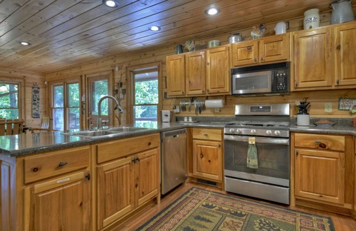 Cherry Log Cabin | Papa Bear Lodge is a Pet-friendly haven featuring hot tub, outdoor fireplace, firepit, pool table, WiFi, and secluded ambiance for unparalleled relaxation