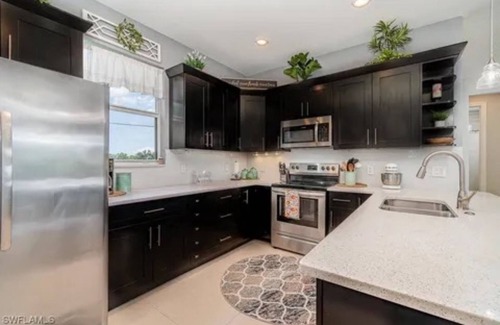 Trafalgar House | Paradise of Cape Coral on Canal, with Heated Pool, Tiki Hut Grill & Elec Bikes