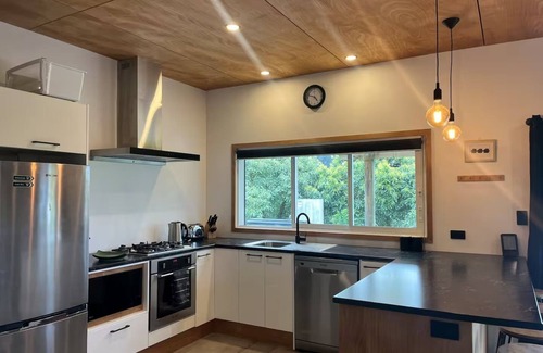 Richmond Downs House | Private Bach in Waihi Beach with stunning orchard views and beyond. Pet-friendly