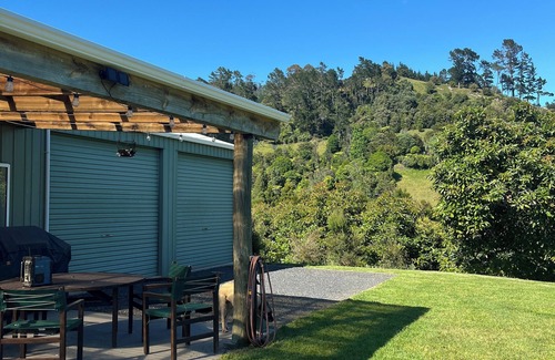 Richmond Downs House | Private Bach in Waihi Beach with stunning orchard views and beyond. Pet-friendly