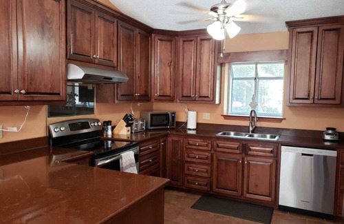 North Northwest Pensacola House | Private Getaway with Screened Pool, Upscale Kitchen, & Large Private Fenced Yard