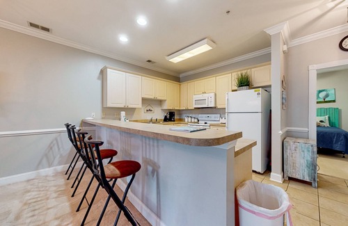 Central Myrtle Beach Condo | Quiet golf community with security, covered balcony, W/D, AC, & pool access