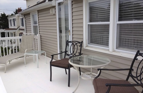 North Beach Haven House | Relax on the deck of this 2nd floor oceanside duplex just steps from the beach.