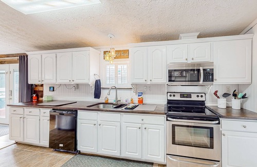 Beulah House | Relaxing lakefront retreat with kayaks, wraparound deck & firepit - dog-friendly