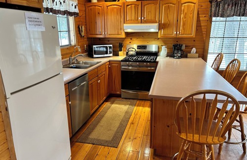 South Haven Cottage | Riverbend Retreat Middle Branch CottagenFireplace and hot tub with river view.