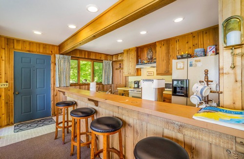 Lake Township House | Rustic dream-home w/lake views, wraparound deck, & wood-burning fireplace