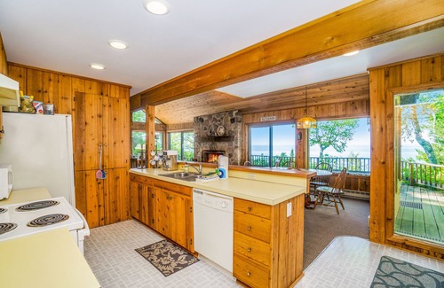 Lake Township House | Rustic dream-home w/lake views, wraparound deck, & wood-burning fireplace