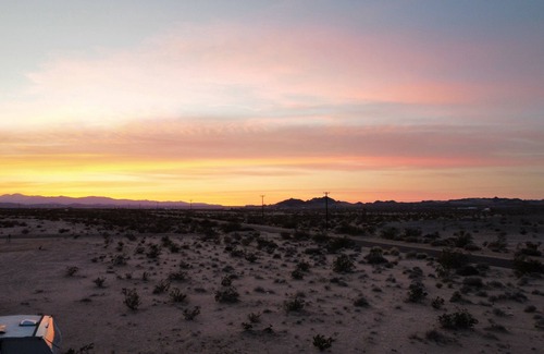 Wonder Valley RV Rental | RV space with fire pit under the stars