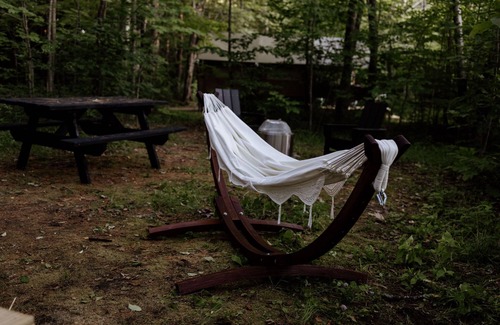 North Woodstock RV Rental | Safari Tent Site 8 | 1 Queen Bed & 2 Bunk Beds | Pond View