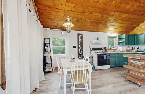 Greenville House | Scenic retreat with a spacious deck, gas fireplace, and Moosehead Lake views